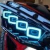 Close-up of a car's futuristic, blue LED headlight design.