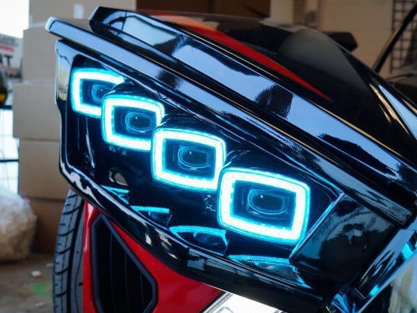 Close-up of a car's futuristic, blue LED headlight design.