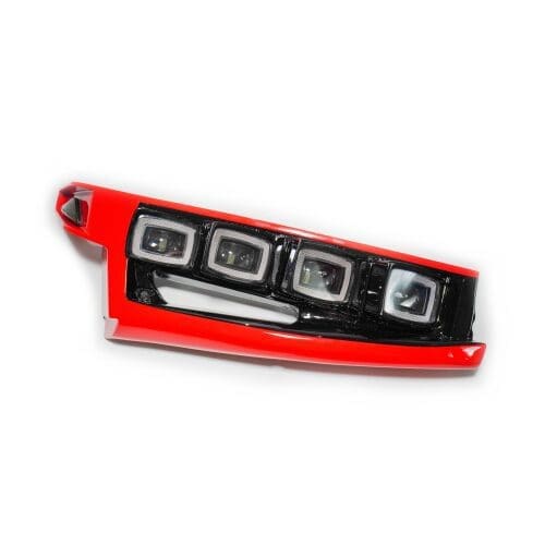 Red and black car tail light with four bulbs on white background.
