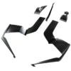 Set of black angular car body kit parts on white background.