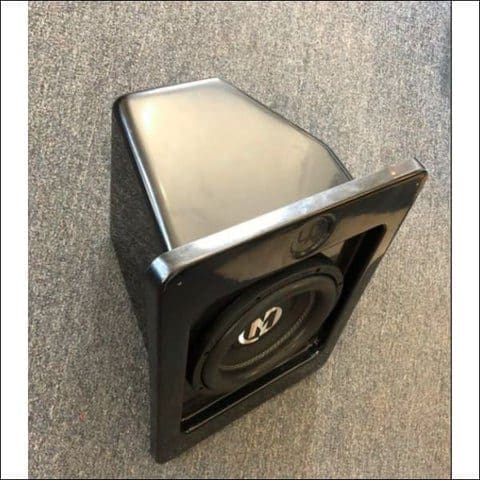 Close-up of a small speaker with a black casing and beige front.