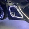 Close-up of a car speaker with LED lighting inside a vehicle door.