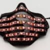 IMG_4046 A black LED mask with colorful lights displaying patterns.