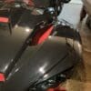 IMG_4367 Close-up of a sleek black and red sports car hood with sharp angles.