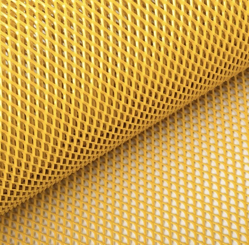 IMG_4534 Close-up of a yellow plastic mesh roll with diamond-shaped holes.