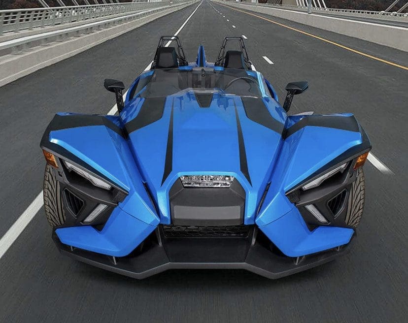 A sleek, blue three-wheeled sports car on a city street.