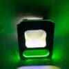 A glowing green and white light box in a dark space.