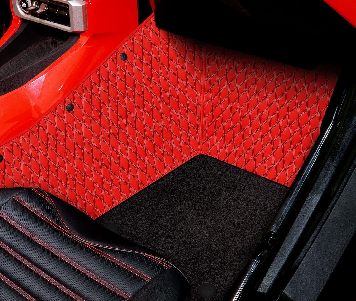 Close-up of a car's red and black carpeted floor mat.