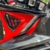 IMG_2413 Close-up of a red and black motorcycle part with a sleek design.
