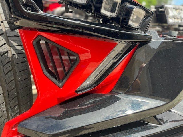 IMG_2413 Close-up of a red and black motorcycle part with a sleek design.