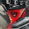 IMG_2414 Black and red car bumper with a grill