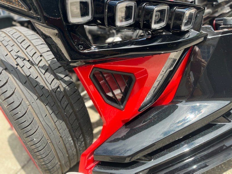 IMG_2414 Black and red car bumper with a grill