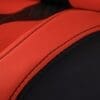 IMG_4961 Close-up of red and black leather upholstery with detailed stitching.