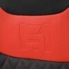 IMG_4962 Close-up of red and black leather with embossed logo and red stitching.