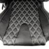 Close-up of a black quilted car seat cover with diamond stitching.