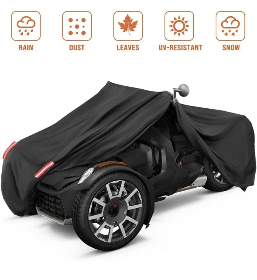 Black cover protecting a three-wheeled vehicle from weather elements.