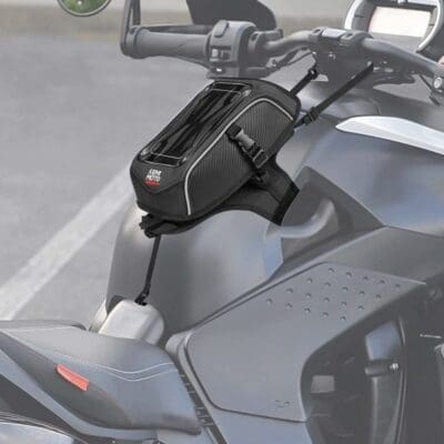 Black motorcycle handlebar bag attached securely.