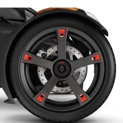 Close-up of a black wheel with red accents and detailed spokes.