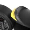 IMG_5043 Close-up of a black tire and textured seat with a yellow accent on a scooter.