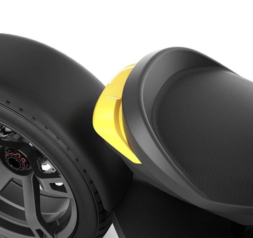 IMG_5043 Close-up of a black tire and textured seat with a yellow accent on a scooter.
