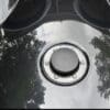 IMG_6979 Close-up of a shiny black motorcycle fuel tank with a chrome fuel cap.