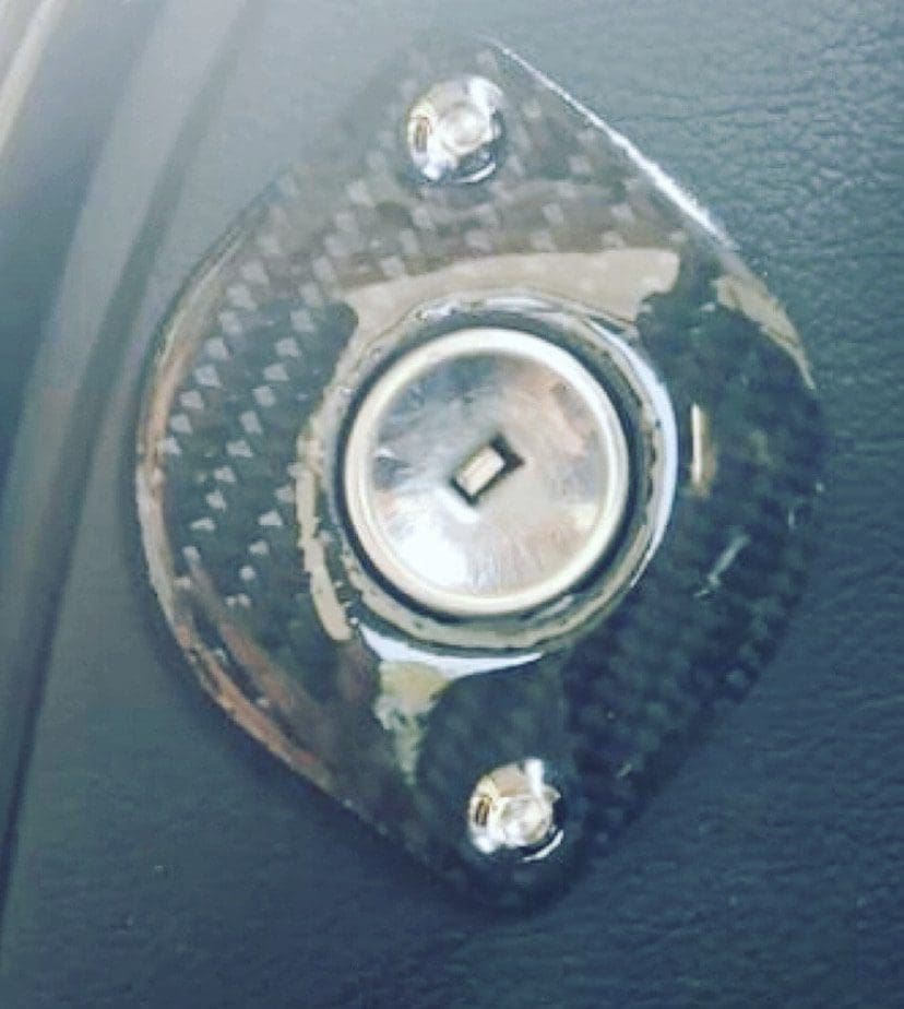 IMG_6985 Close-up of a metallic rotary knob on a carbon fiber base.