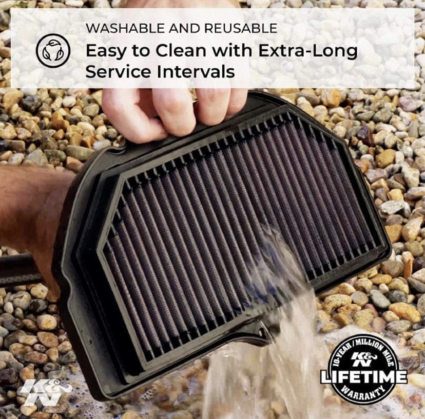 Hand washing a reusable air filter on gravel, promoting easy cleaning.
