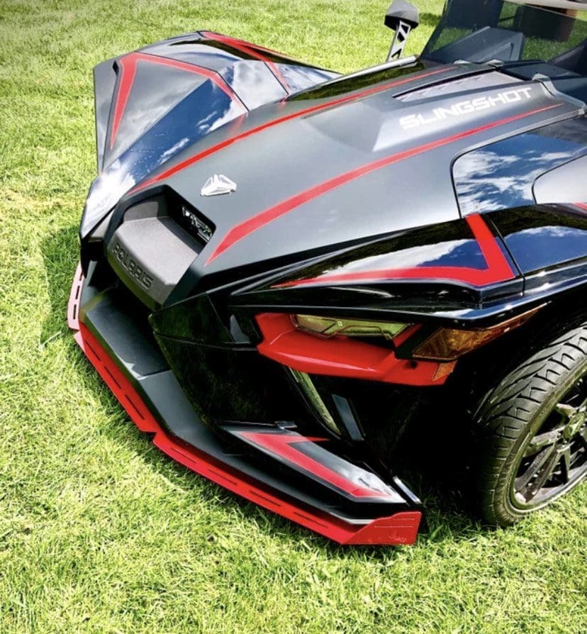 IMG_7275 Close-up of a sleek black sports car with red accents on grass.