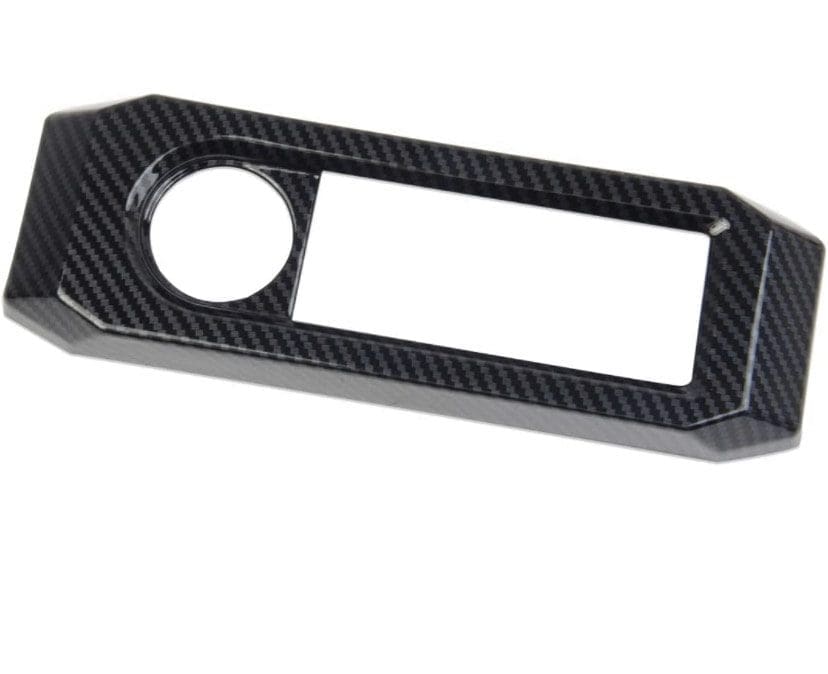 IMG_7411 Carbon fiber car dashboard panel with circular and rectangular cutouts.