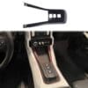 IMG_7412 Car interior showing gear shift area with a nearby plastic trim piece.