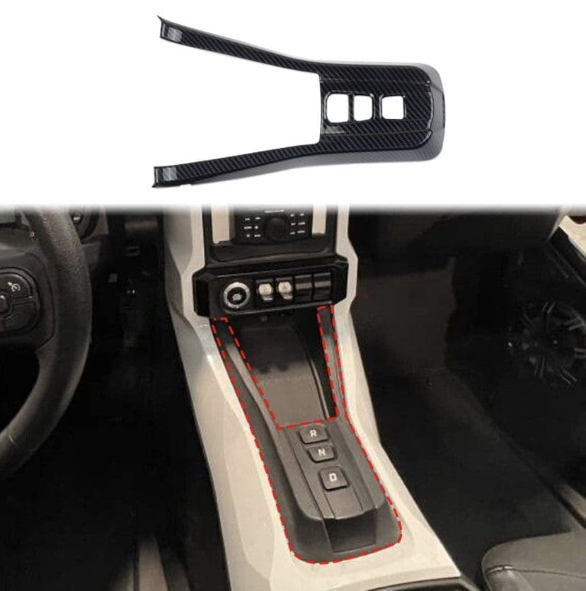 IMG_7412 Car interior showing gear shift area with a nearby plastic trim piece.