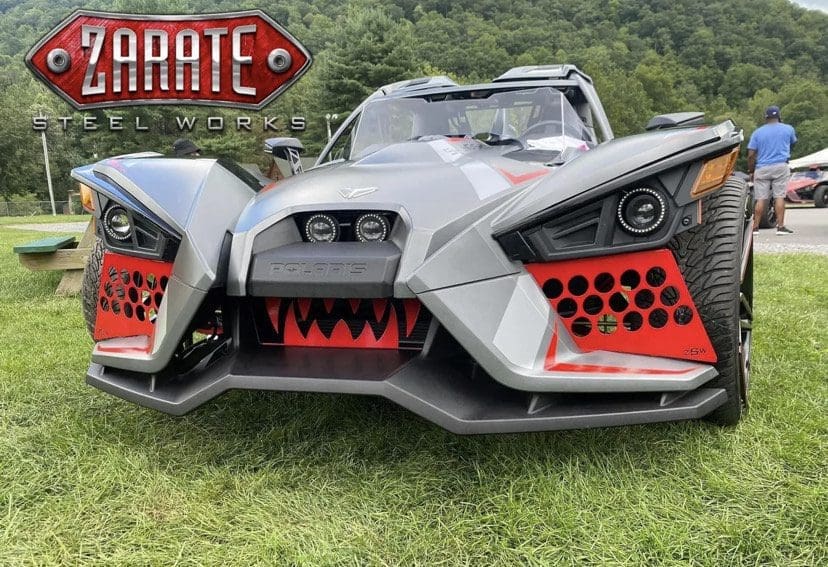 IMG_7663 A custom Polaris vehicle with aggressive design and Zarate Steel Works branding.