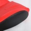 657e8d3c-7571-4115-bd53-b1eebb9f1c8c Close-up of a red rubber boot with a textured black sole.