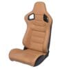8d2bb712-79f6-45ba-9ad6-02722b3f86a8 Tan racing car seat with black base and harness slots.