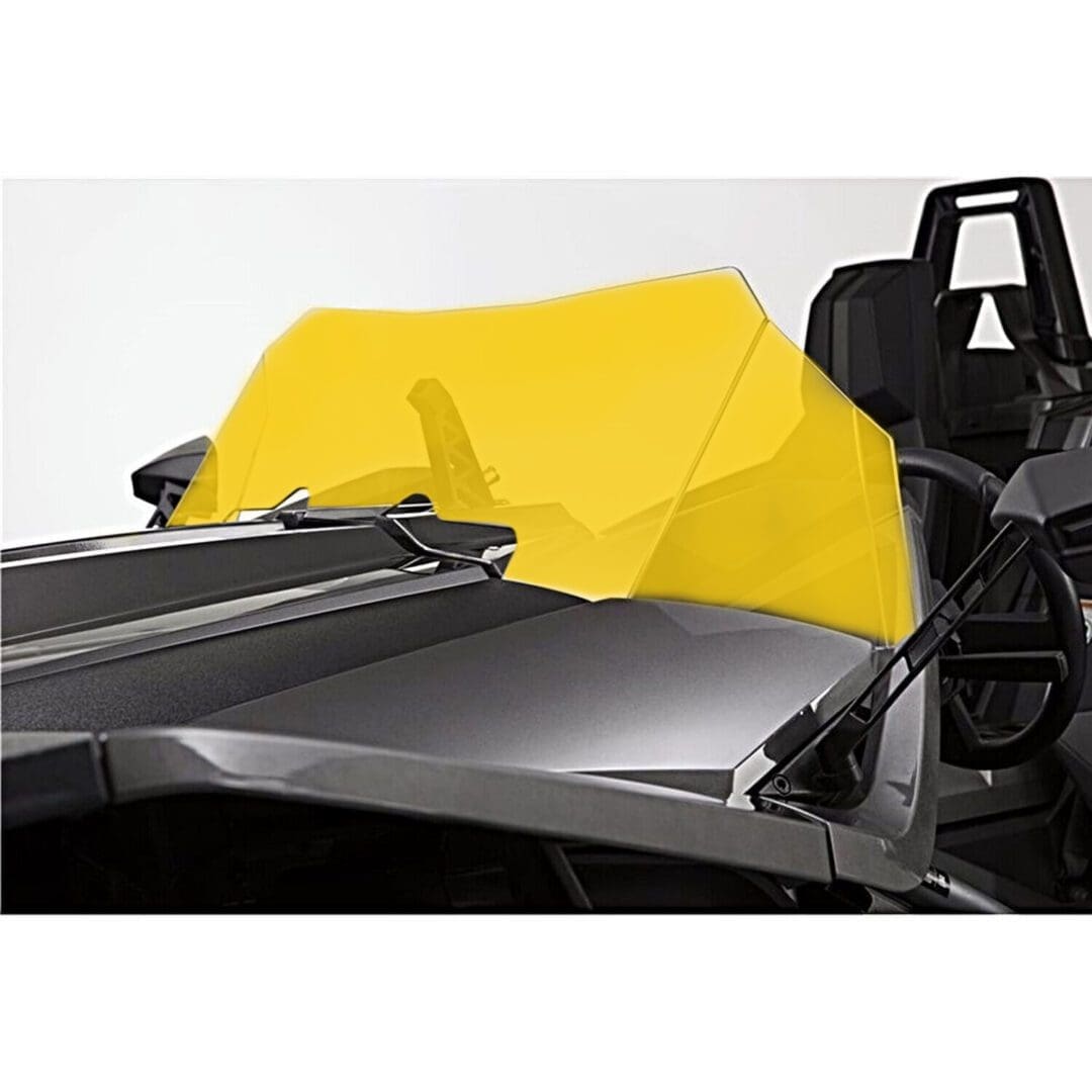 MAIN_Yelllow Close-up of a sleek black racing car with a bright yellow cockpit cover.