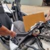 image000002-scaled Two people working on a car engine with the hood open.
