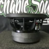 image_e91f57da-95af-4561-86d2-144e7a925dc4 Side view of a black subwoofer speaker on a gray surface.