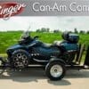 A Can-Am Spyder on a trailer in a rural area.