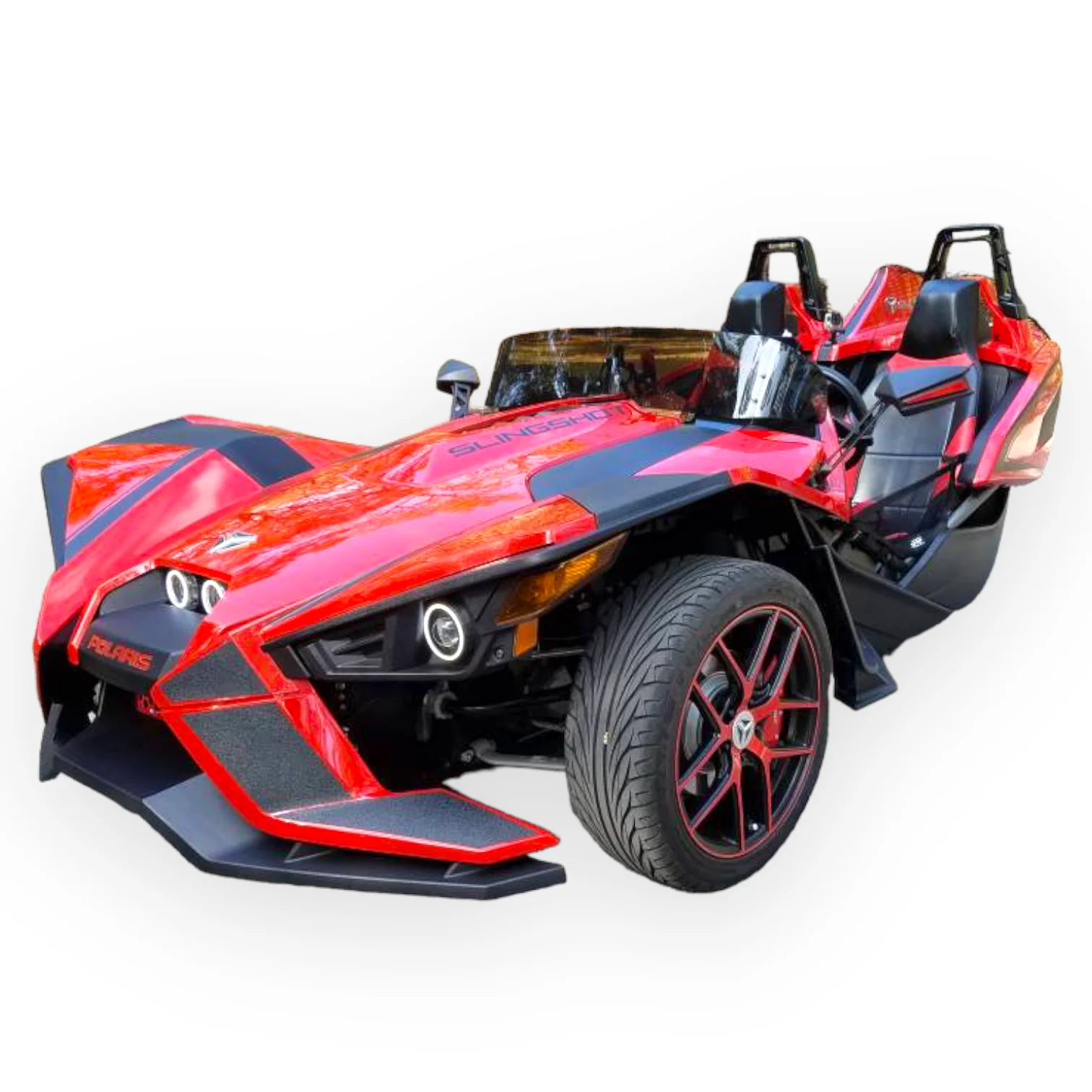 image_9cefd1bb-816e-4029-88bc-fe3a8c2ffa38_1800x1800 A sporty, open-top three-wheeled car with red and black design.