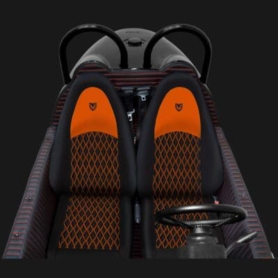 Top-down view of a two-seater vehicle with orange and black seats.