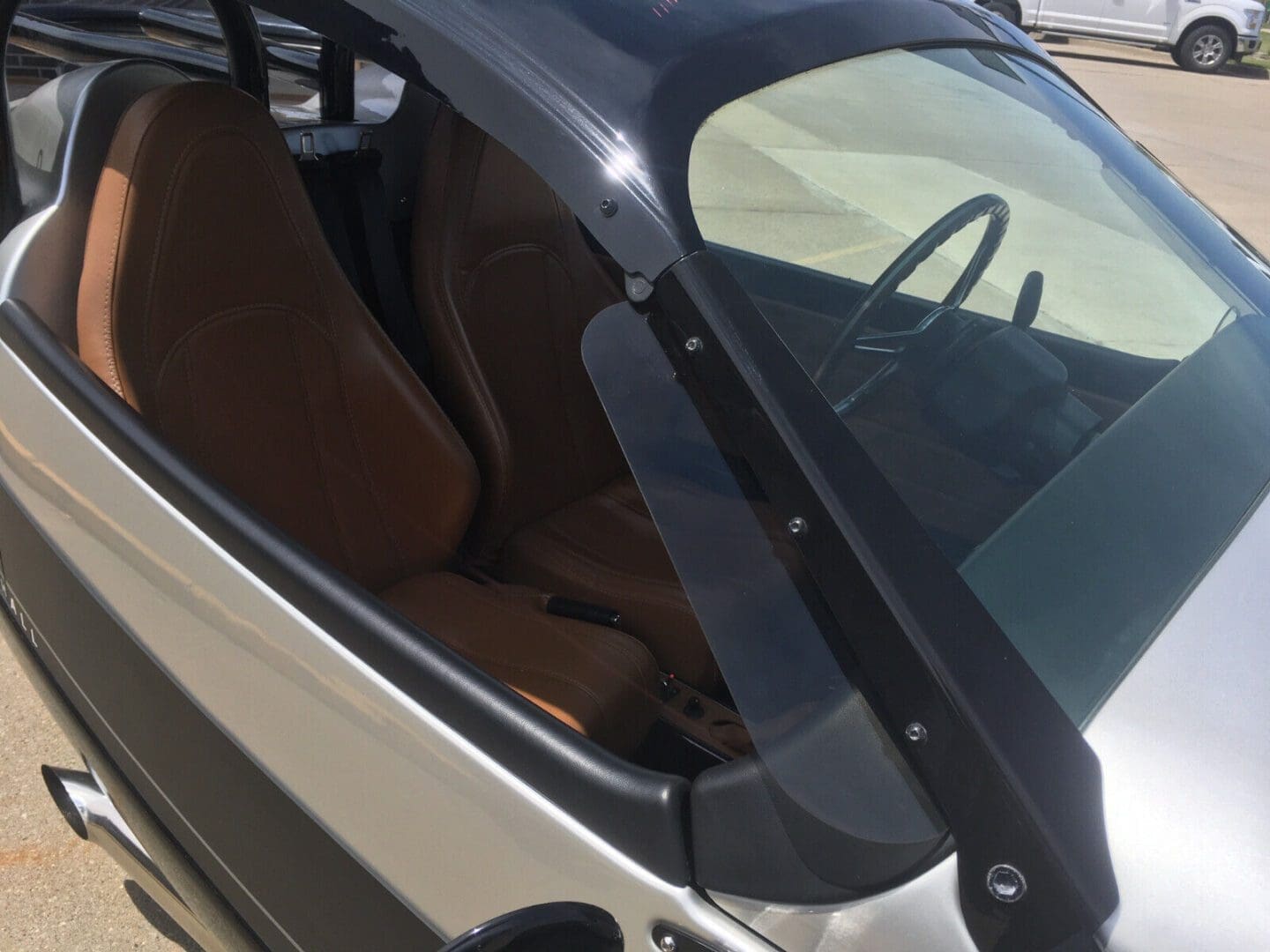s-l1600 (4) Close-up of a small car's interior showing the driver seat and windshield.