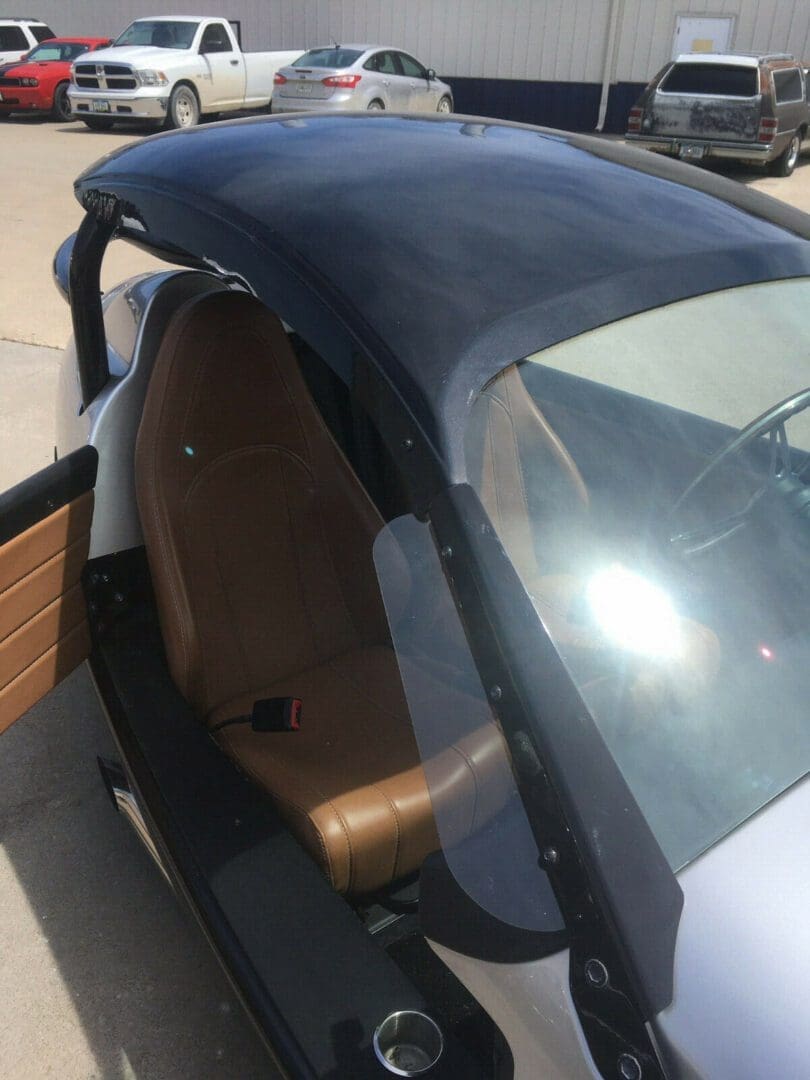 s-l1600 (7) Close-up of a car's interior with a leather seat and window frame.