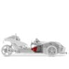 White three-wheeled vehicle with exposed mechanical parts and red seat.