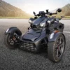 EN-JS6-Package-2000X2000-1_3000x A sleek black three-wheeled motorcycle parked on a road.