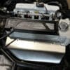 Close-up of a car engine's air intake system with a filter.