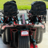 Rear view of two go-karts parked side by side under a canopy.