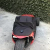 s-l1603 A black and red motorcycle covered with a black protective sheet.