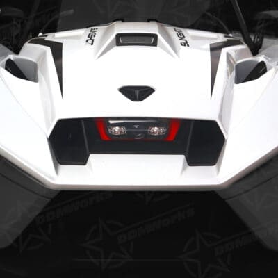 Close-up of a sleek white sports car's rear end with sharp angles and a central exhaust.