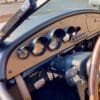 img_1061 Classic car dashboard with vintage gauges and wooden steering wheel.